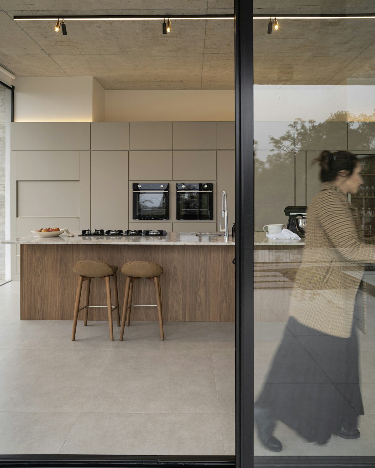 Finished kitchen and living extension opening onto the garden through full-height glazing