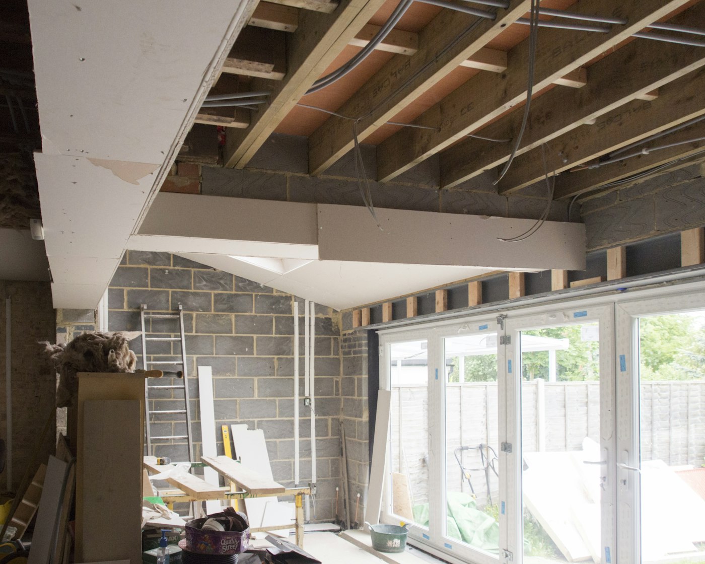 Structural steel beam installed above a newly opened rear wall during a renovation
